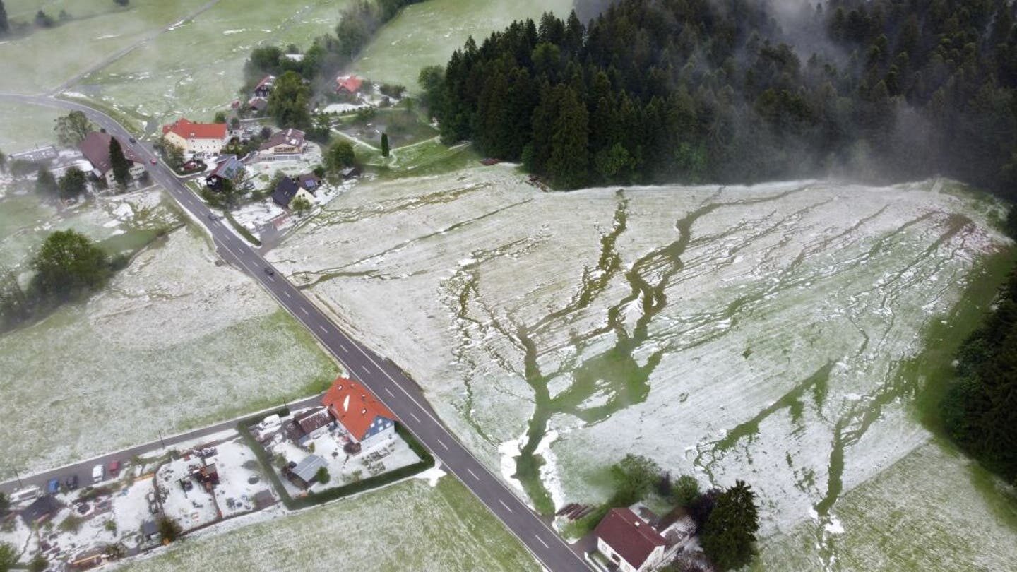 Click to enlarge 05 June 2022, Bavaria, Weiler im Allgäu: Winter landscape looks from the bird's eye view after a heavy hailstorm has fallen.