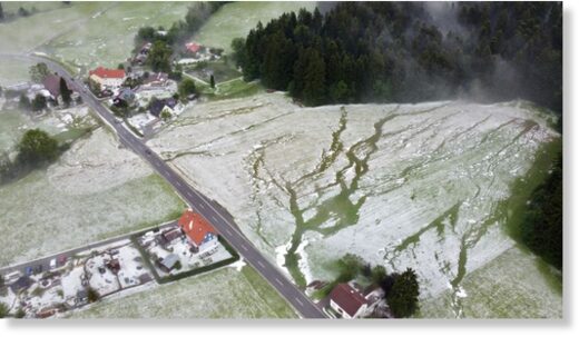 05 June 2022, Bavaria, Weiler im Allgäu: Winter landscape looks from the bird's eye view after a heavy hailstorm has fallen.