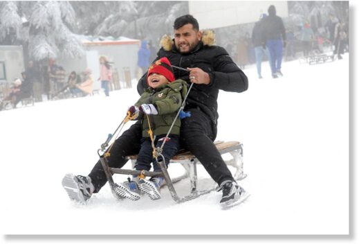Click to enlarge Algerians slide with a sledge at a ski center after snowfall in highlands of Cheria town in Tebessa Province, Algeria on Janaury 23, 2023.