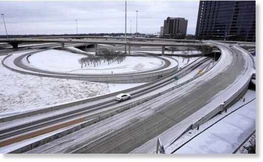 A lone driver makes their way through icy road conditions at the LBJ 635 Freeway and North Dallas Tollway interchange on Tuesday.