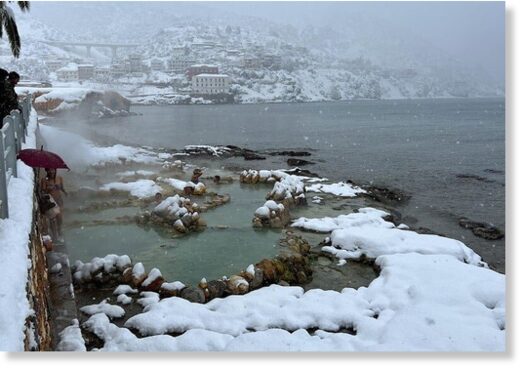 The coastal town of Aidipsos in Evia is covered in snow.