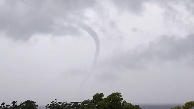 Australia's east coast has been smashed with a barrage of wild weather as a 'tornado' is captured on camera near Sydney