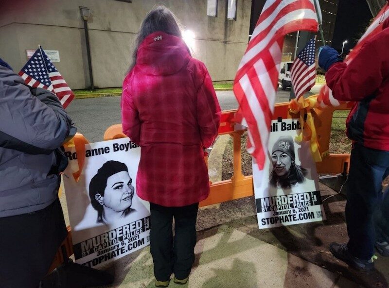 Click to enlarge Posters of two of the murdered victims on January 6