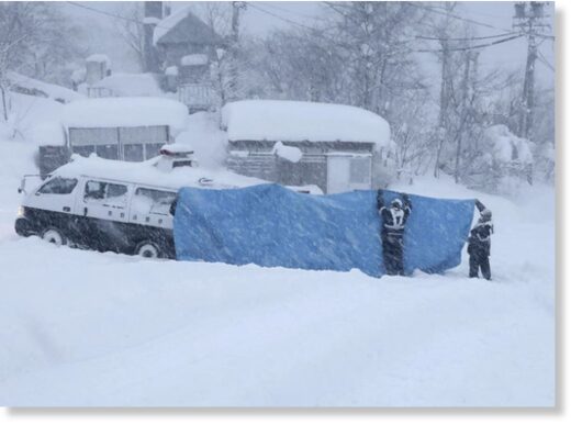 File - Rescue crews work to recover bodies after an avalanche