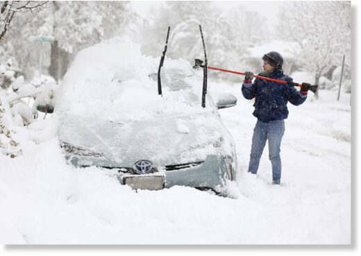 Click to enlarge Cathy Morgan-Mace cleans snow and ice off her family's car during a snowstorm in Salt Lake City, Utah, on Wednesday, Feb. 22, 2023.