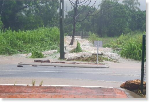 Click to enlarge Cedar Road at Palm Cove, north of Cairns, was in full flood on Monday morning.