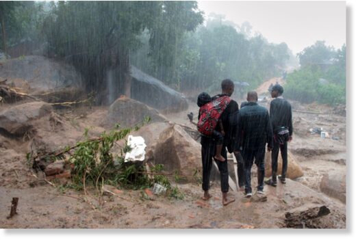Click to enlarge People look at the damage caused by Cyclone