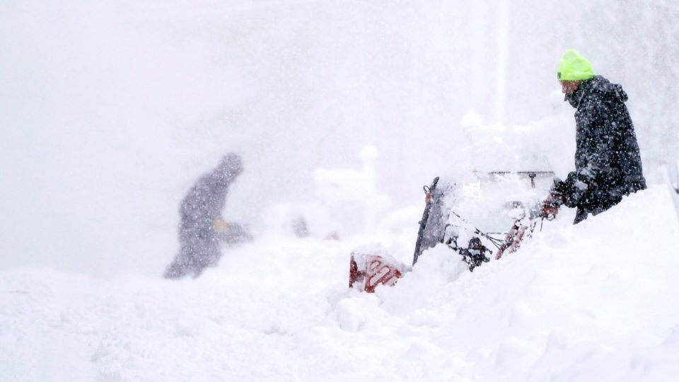 Neighbors clear their driveways in near whiteout conditions on Tuesday in East Derry, New Hamphsire.