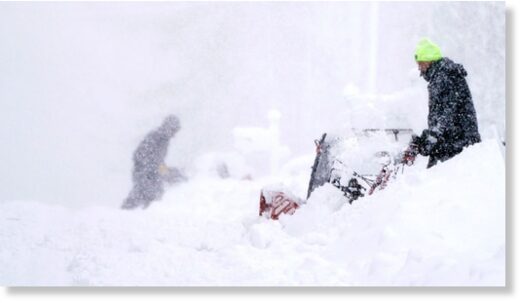 Click to enlarge Neighbors clear their driveways in near whiteout conditions on Tuesday in East Derry, New Hamphsire.