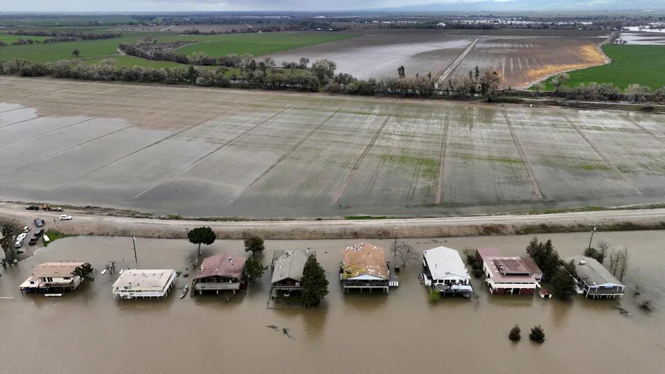 Click to enlarge Houses sit partly underwater after the San Joaquin River flooded following rainstorms in Manteca, California on Sunday.