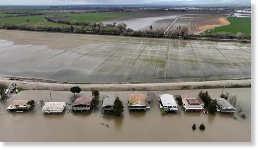 Click to enlarge Houses sit partly underwater after the San Joaquin River flooded following rainstorms in Manteca, California on Sunday.
