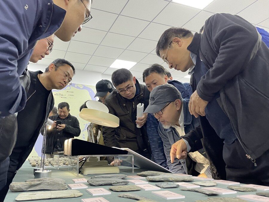 Experts observe the stone relics