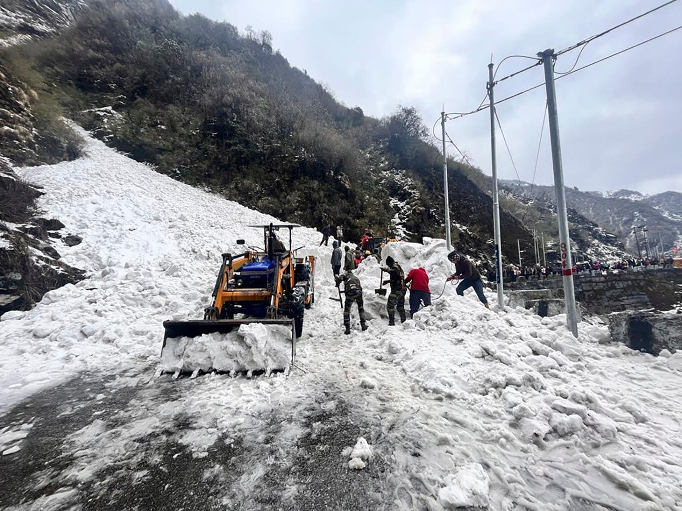 In this handout photo released by the Indian Army, soldiers clear snow from an avalanche near Nathu La mountain pass in India’s Sikkim state on 4 April