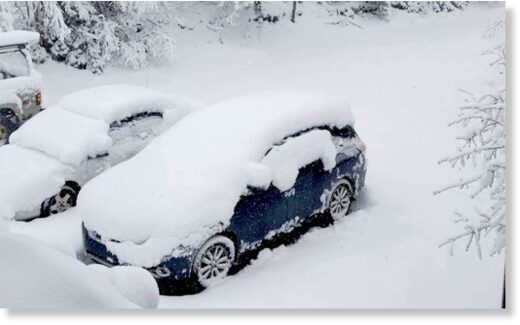 Click to enlarge Vehicles buried in more than foot of snow in Ishpeming, Michigan on May 1, 2023.