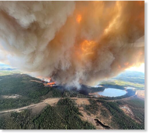 Click to enlarge A smoke column rises from wildfire EWF031 near Lodgepole, Alberta, Canada May 4, 2023.