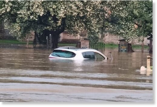 Car submerged in floodwater at the A359 in Queen Camel