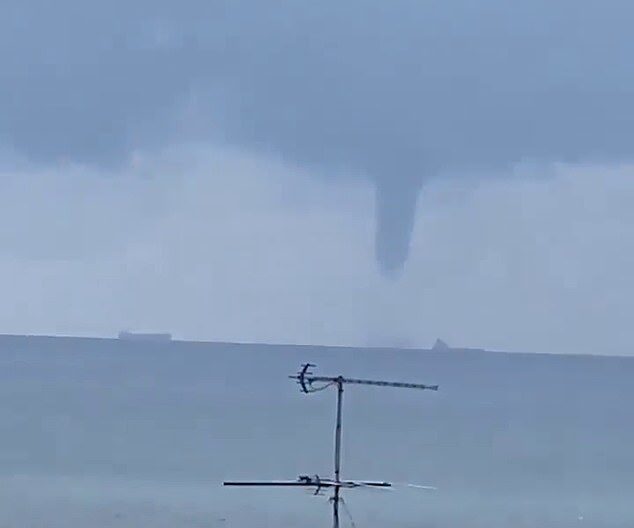 Click to enlarge A huge tornado-like water spout that dwarfed tankers (pictured) has been spotted off the coast of Sydney as a storm moves its way onto land