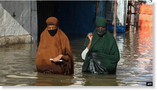 Click to enlarge Women walk through floodwater in Beledweyne, Somalia, May 12, 2023.
