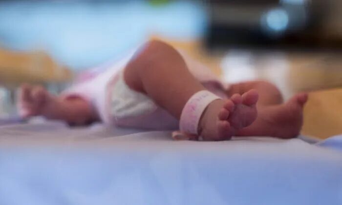 Click to enlarge Stock photo of the feet of a new-born.