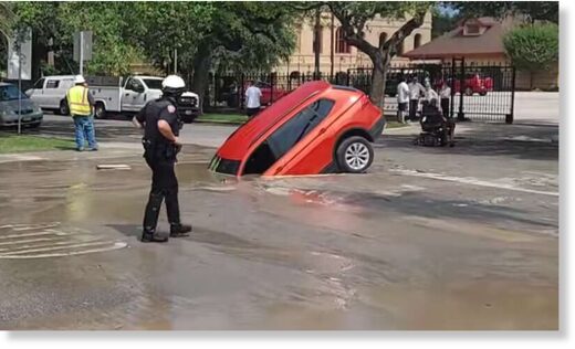 Click to enlarge A man narrowly escaped from a car window after driving into a sinkhole in Galveston on Tuesday, May 23.