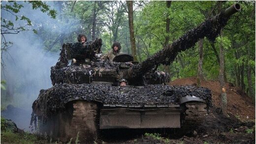 Ukrainian soldiers on a tank ride along the road towards their positions in Donbass