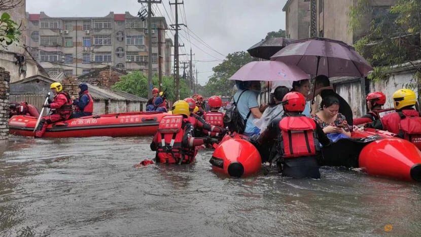 Rescue workers evacuate stranded residents on a flooded street following heavy rainfall in Beihai, Guangxi Zhuang Autonomous Region, China, Jun 8, 2023.
