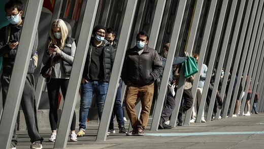 People line up at a vaccine hub in Melbourne.