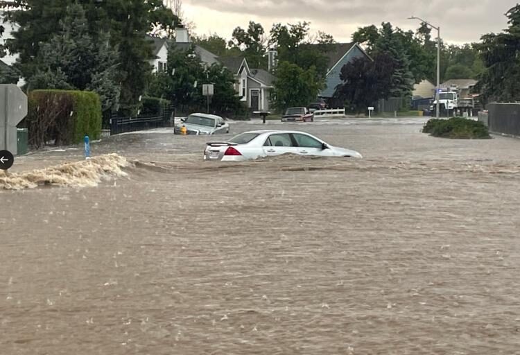 A car is submerged in a flooded street in Colorado Springs on Monday.