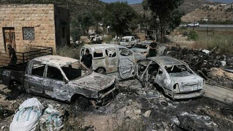 Torched cars in the village of Lubban al-Gharbi