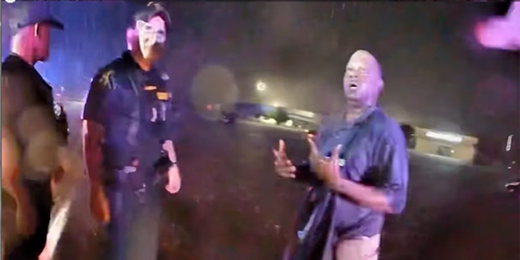 Click to enlarge Escambia County sheriff's deputies assist a man rescued from floodwaters on Friday, June 16, 2023. The citizen and a deputy were both sucked into a drain pipe during a rescue attempt.