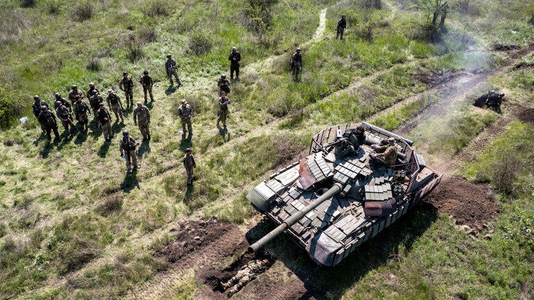 Click to enlarge A Ukrainian Army tank drives over an infantryman during a training exercise.