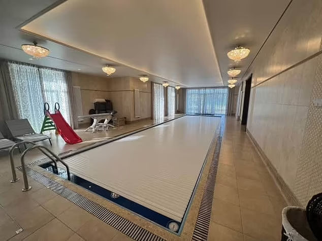 Click to enlarge Prigozhin's private swimming pool in his St Petersburg palace, complete with a tiny slide