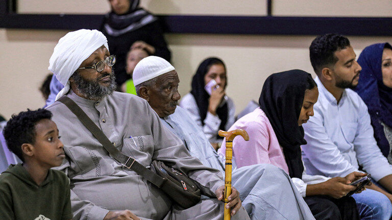 Click to enlarge Evacuees from Sudan wait upon arrival at Baghdad International Airport on June 18, 2023