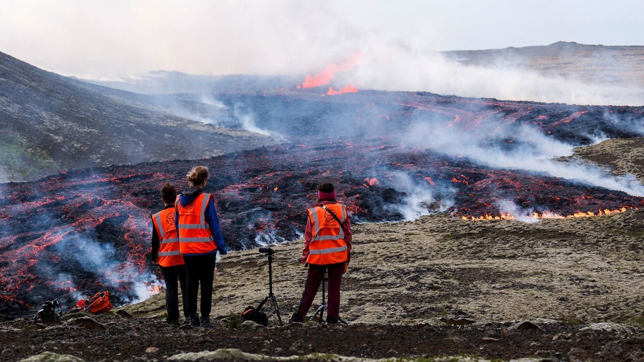 Observers from the University of Iceland watch a volcanic eruption near Litli Hrutur, Iceland on July 10, 2023.