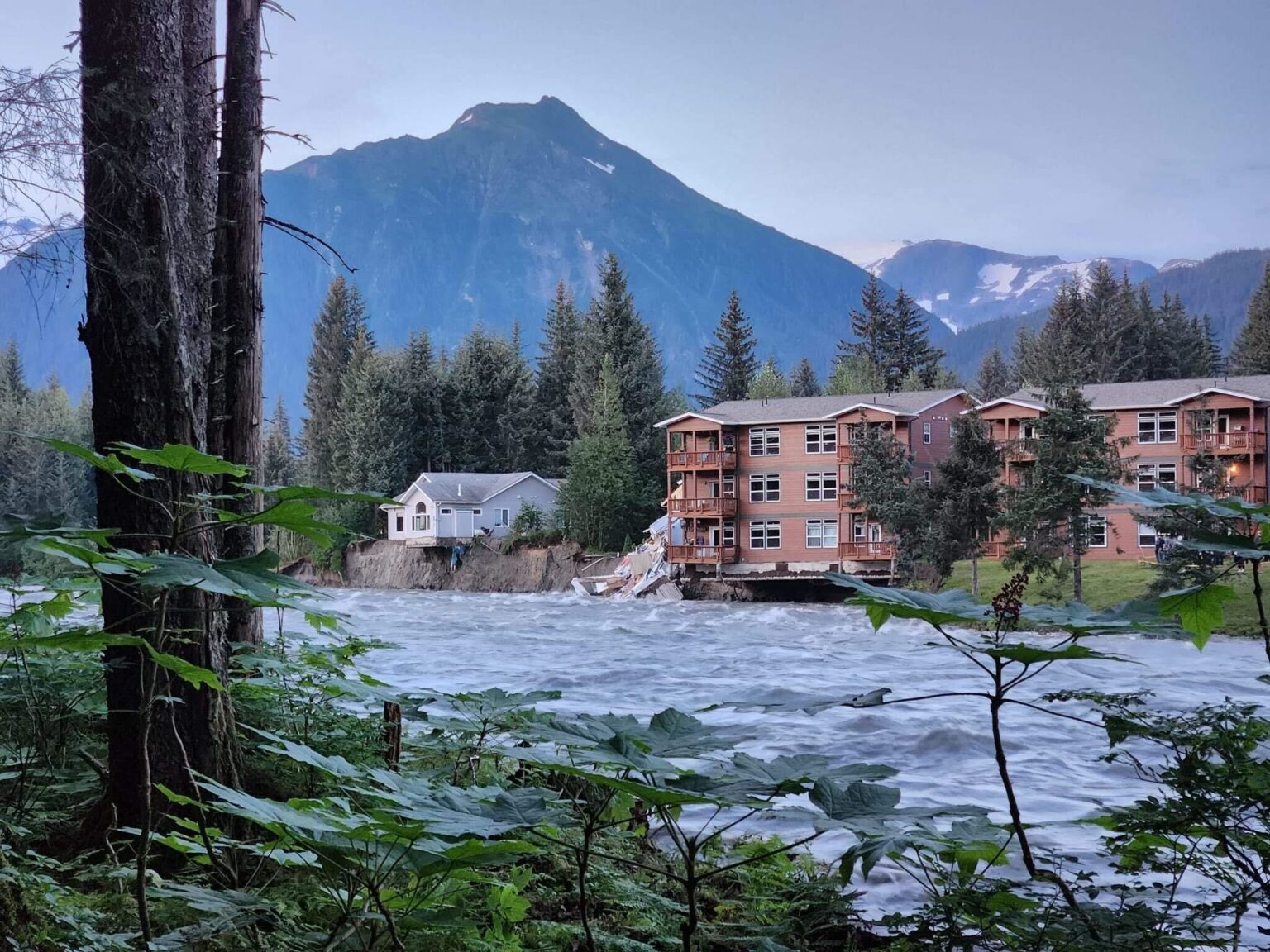 At least one home along Riverside Drive collapsed after severe glacial outburst flooding in Mendenhall River eroded the bank