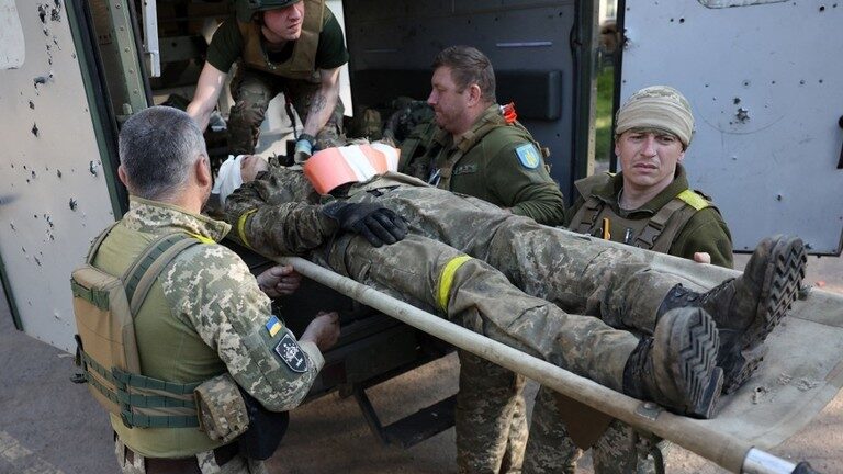 Military medics evacuate a wounded Ukrainian serviceman near the front line in Donetsk Region
