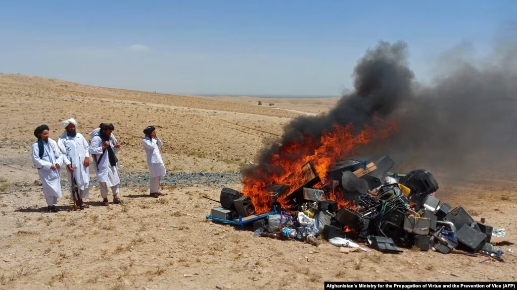Click to enlarge taliban morality police music burning