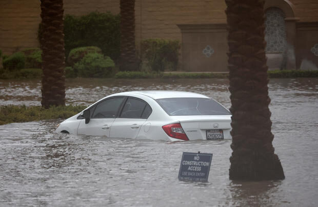 Click to enlarge A car is partially submerged in floodwaters as Tropical Storm Hilary moves through Cathedral City, California on August 20, 2023.