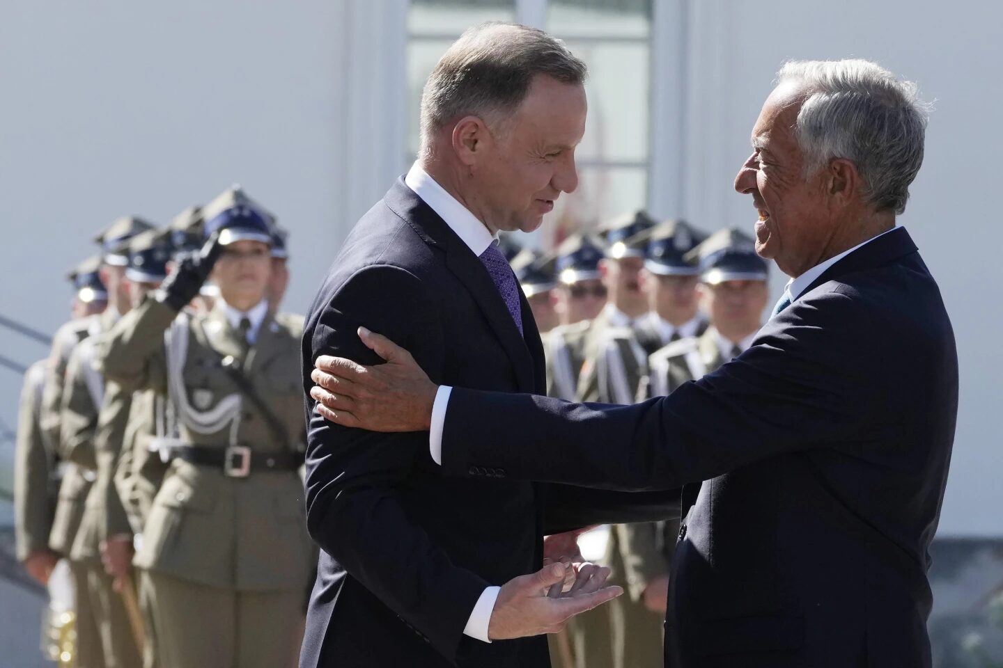 Poland's President Adrzej Duda, left, greets, Portuguese President Marcelo Rebelo de Souze