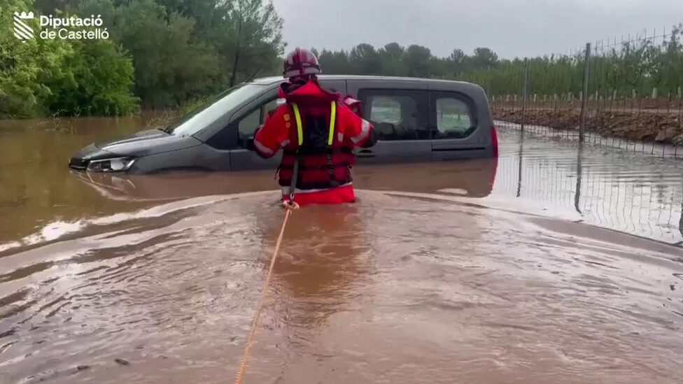 Click to enlarge One man had to be rescued from his car by a firefighter in Spain's eastern Castelló province