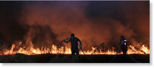 Click to enlarge Firefighters attempt to extinguish a fire that razes through a peatland field in Ogan Ilir South Sumatra, Indonesia, Tuesday, Sept. 12, 2023.