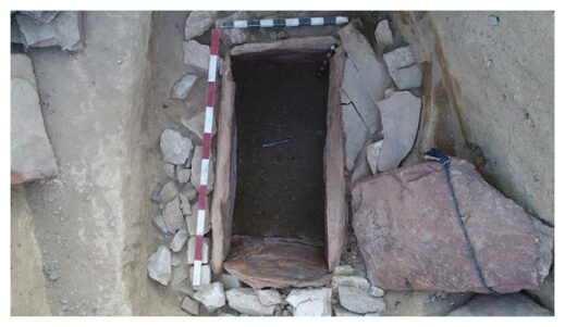 The stone-lined burial at the center of the pyramid.