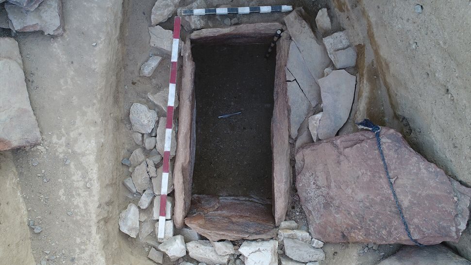 The stone-lined burial at the center of the pyramid.