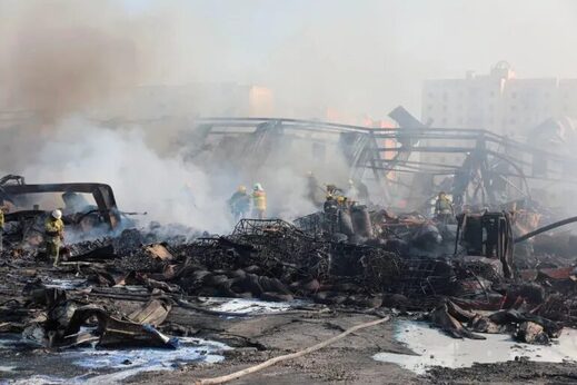 Click to enlarge Specialists work to extinguish fire following an explosion at a warehouse near an airport in Tashkent