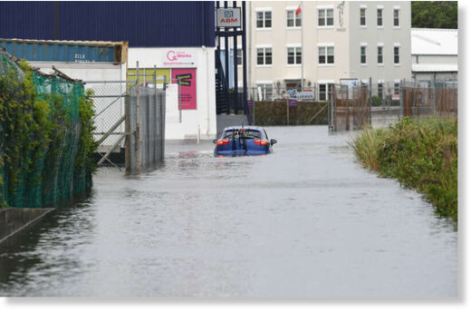 Click to enlarge Drivers did their best to navigate flooding after heavy rainfall across the island. Pictured is a car stuck on Mill Creek Road