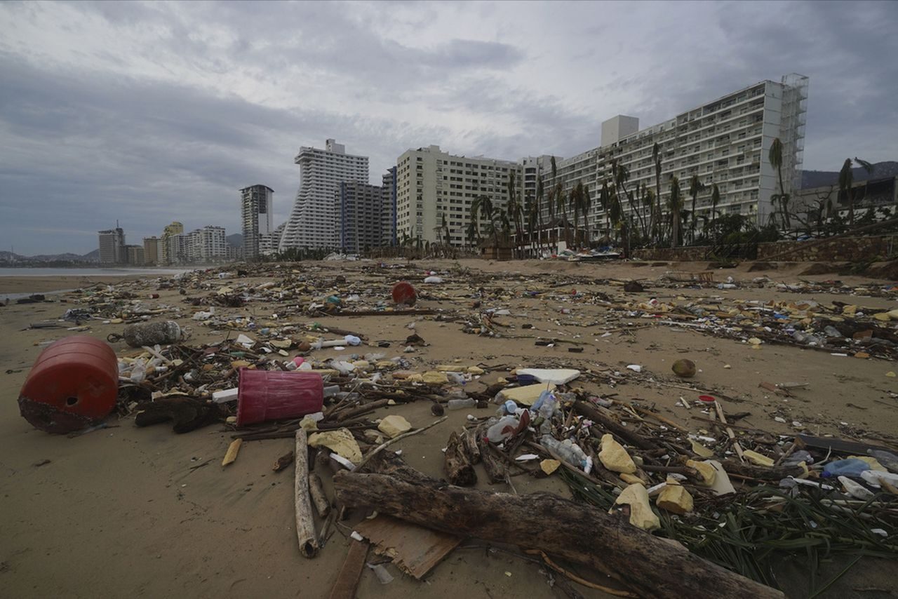 Debris lays on the beach after Hurricane Otis