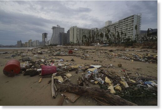 Debris lays on the beach after Hurricane Otis