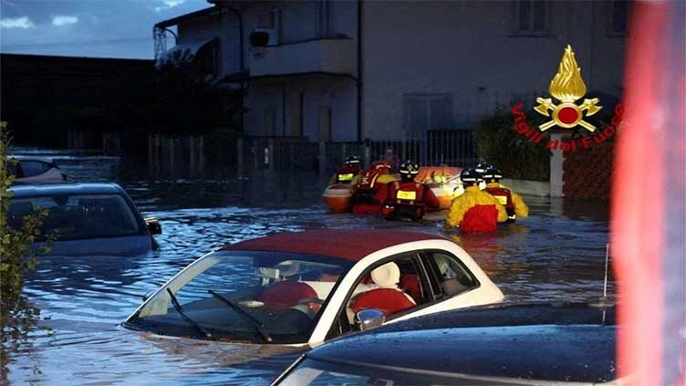 Italian firefighters work in flooded streets in the