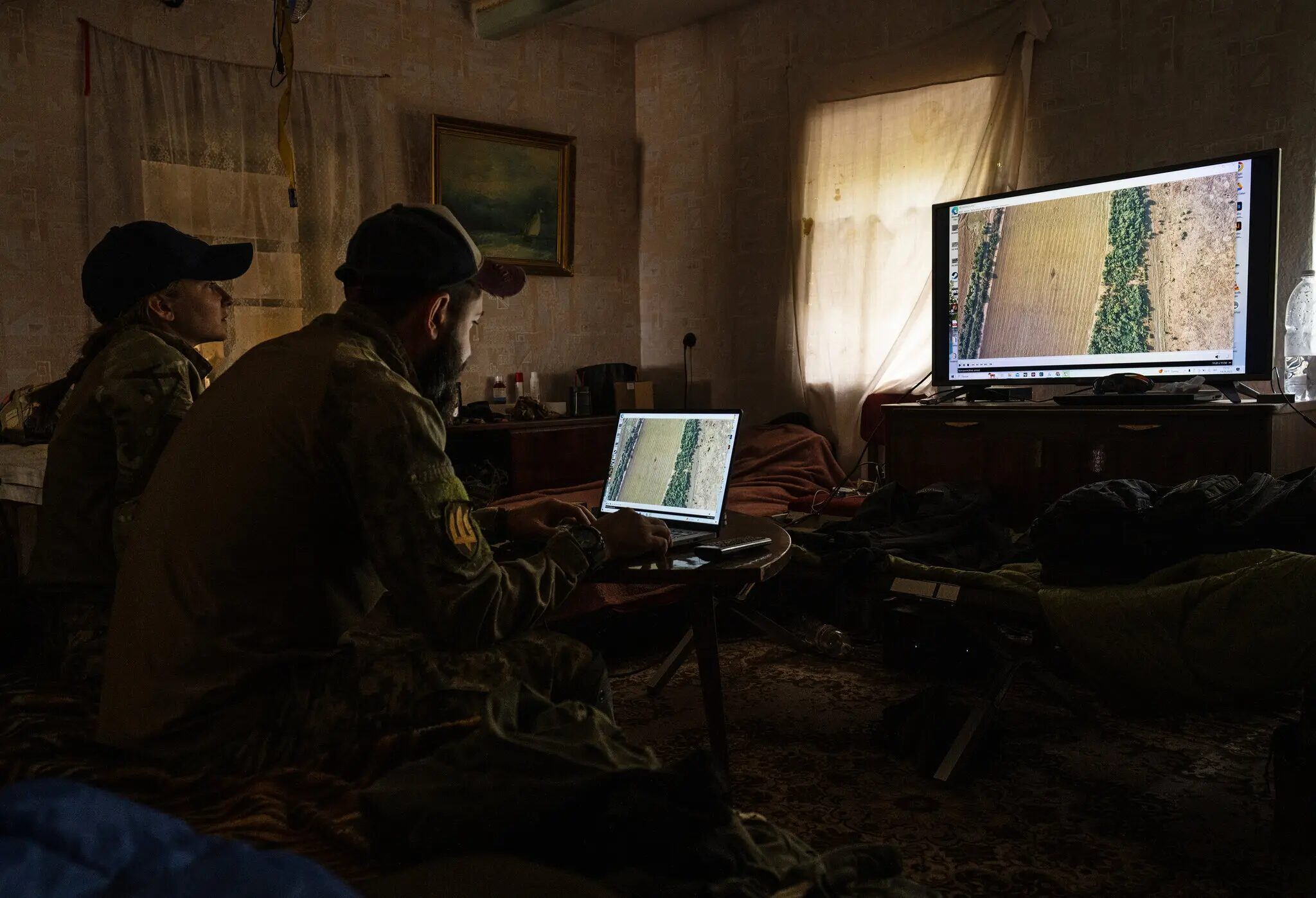 A pilot and his navigator reviewing footage at a base in the Zaporizhzhia region