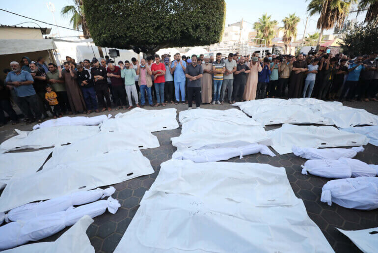 Click to enlarge Relatives of Palestinians who died in Israeli airstrikes